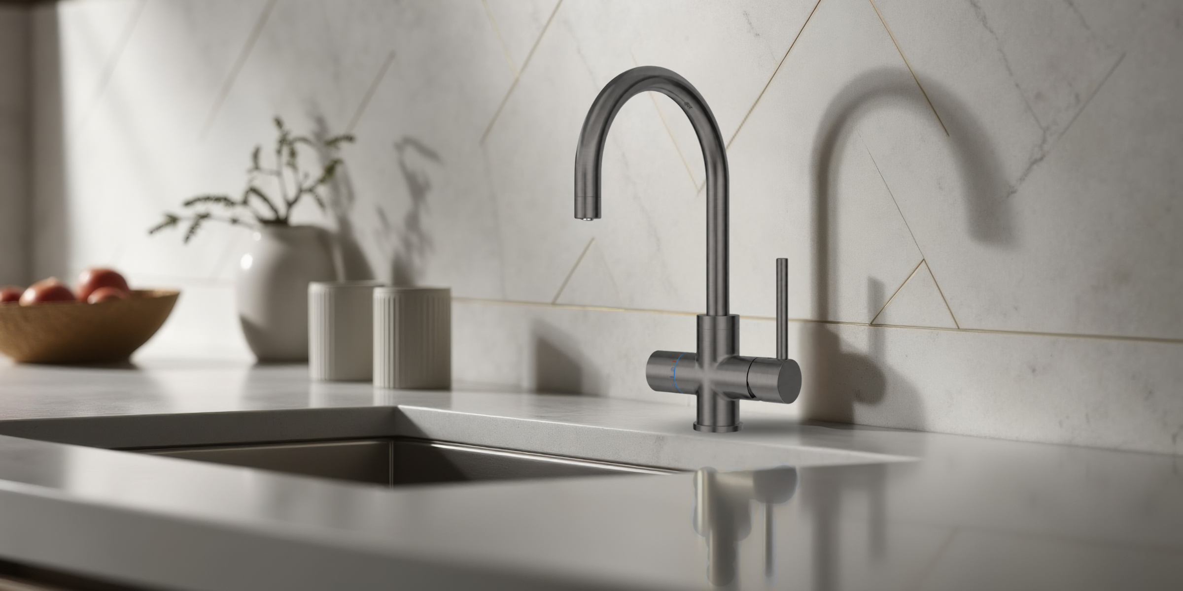 Modern kitchen sink with a faucet in a clean, minimalistic setting.
