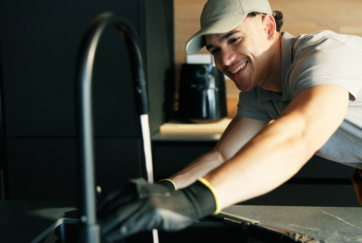 Plumber working on a kitchen sink