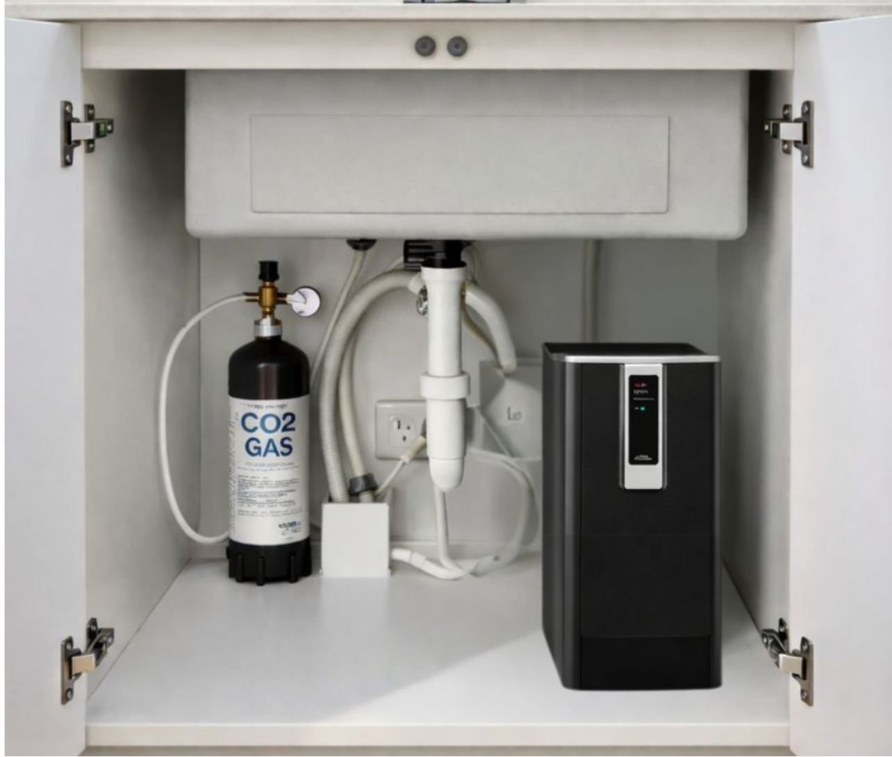 CO2 gas cylinder and machine under a kitchen sink with visible plumbing.