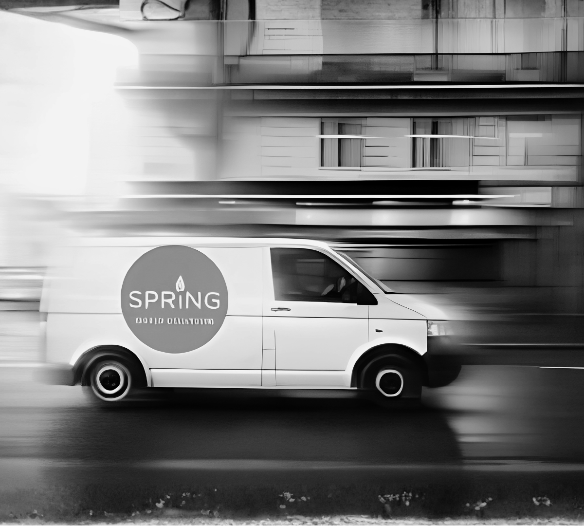White van with 'Spring' logo driving on a blurred road