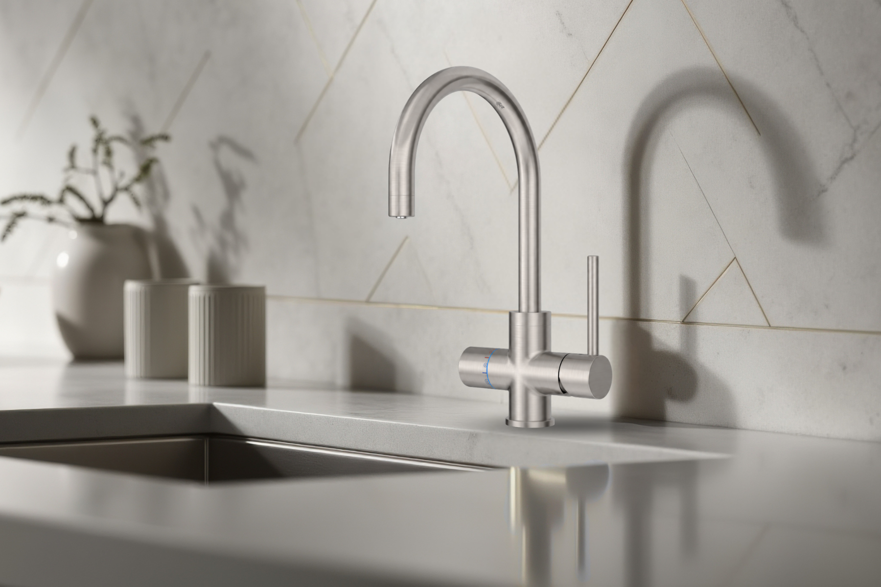 Modern kitchen faucet on a marble countertop with a tiled wall background